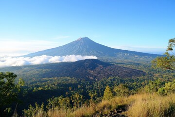 Fototapeta premium Majestic Twin Volcanic Peaks Rise Above Cloudscape