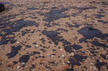 Fuel oil stains on the Black Sea coastline. Environmental disaster, environmental pollution. Oil spill