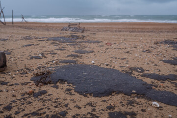 Fuel oil stains on the Black Sea coastline. Environmental disaster, environmental pollution. Oil...