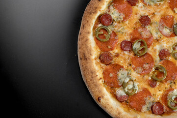 details of the pizza application; juicy pizza from the oven with mushrooms, tomatoes and bacon and sprinkled with parmesan cheese
