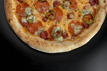 details of the pizza application; juicy pizza from the oven with mushrooms, tomatoes and bacon and sprinkled with parmesan cheese