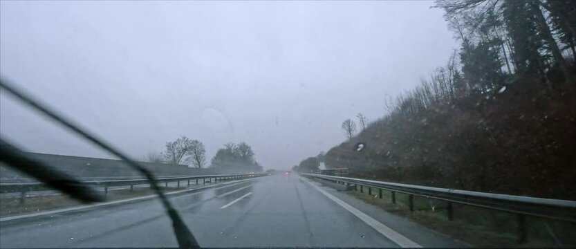 POV: Driving on German Autobahn on a rainy day in winter 