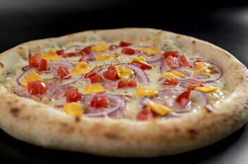details of the pizza application; juicy pizza from the oven with mushrooms, tomatoes and bacon and sprinkled with parmesan cheese