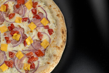 details of the pizza application; juicy pizza from the oven with mushrooms, tomatoes and bacon and sprinkled with parmesan cheese