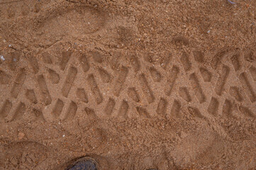 A footprint in the sand from a truck wheel. The Black Sea coast. Elimination of a terrible environmental disaster, fuel oil spill in the sea