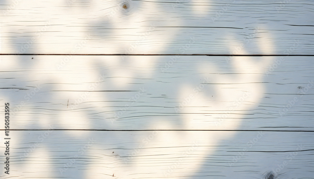 Wall mural wooden planks with a light blue-gray color and visible wood grain, with shadows from overhead foliag