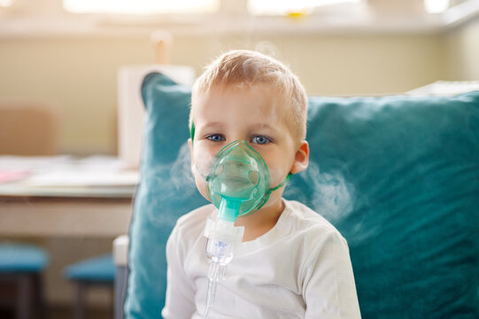 Cute little kid boy wear use medical nebulizer mask inhaling steam respiratory therapy lungs rsv allergic disease cure. Portrait child treating seasonal respiratory bronchitis cough medical inhaler