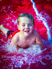 child playing on a water slide