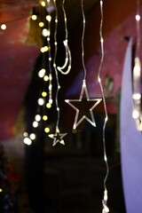 Enjoy festive star and light decorations in a cozy, dim setting, creating a joyful atmosphere