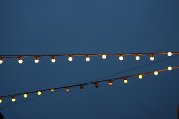 Fototapeta premium The sparkling twinkling lights create a beautiful display against a deep blue night sky
