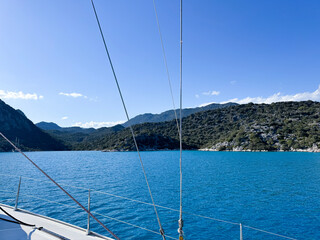 Beautiful turquoise bay surrounded by hills on a sunny day during sailing trip