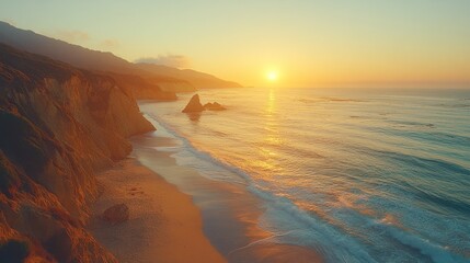 Sunset over dramatic coastline, ocean waves on sandy beach.