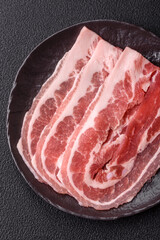 Fresh raw bacon sliced with spices and herbs