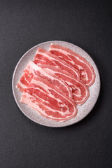 Fresh raw bacon sliced with spices and herbs