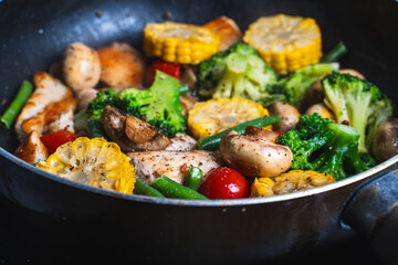Corn, broccoli, mushrooms and green beans are fried in a pan. Close-up. The concept of healthy eating. Filling for making quiche