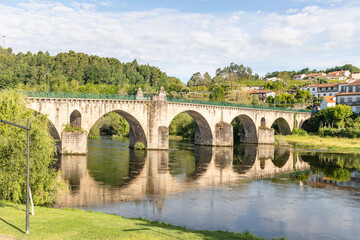 Fototapeta premium Medieval bridge over Lima river in Ponte da Barca, Alto Minho, district of Viana do Castelo, Portugal