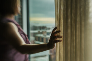 woman looking through window
