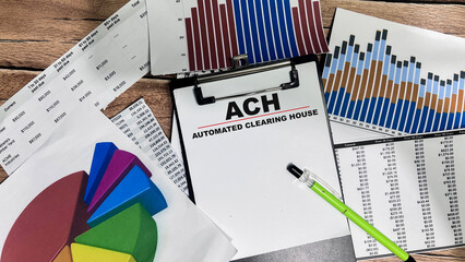 Concept of ACH - Automated Clearing House write on paperwork isolated on Wooden Table.