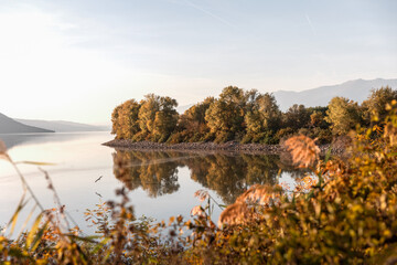 Beautiful autumn scenery on Kerkini lake Macedonia Greece, fisherman and a boat, dalmatian pelicans waiting for fish