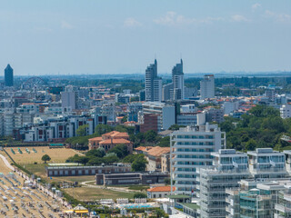 Fototapeta premium Italy, Jesolo near Bibione. Lido di Jesolo, or Jesolo Lido, is the beach area of the city of Jesolo in the province of Venice, Aerial View with sandy beach and with an endless parasols
