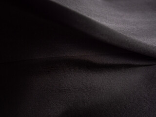 Obraz premium Close-up of black silk fabric. Background, texture