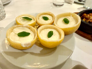 Lemon sorbet ice cream with peel served at plate