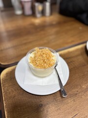 Traditional milky crispy Ramadan dessert custard pudding with roasted kadayif and diced pistachio . Kadayifli Muhallebi