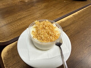 Traditional milky crispy Ramadan dessert custard pudding with roasted kadayif and diced pistachio . Kadayifli Muhallebi