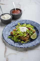 Mexican Taquitos with Lettuce, Cream and Red Salsa