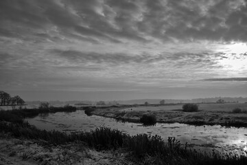 floes on the Warta River and snow-covered bushes and trees during winter