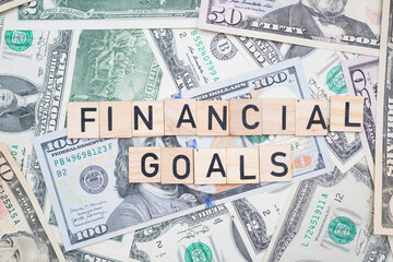 Financial Goals Text Overlaid on Background of U.S. Dollars - Achieving Economic Success