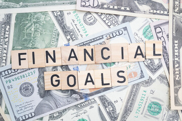 Financial Goals Text Overlaid on Background of U.S. Dollars - Achieving Economic Success