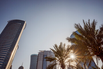 Bottom view of skyscrapers and tall buildings in Doha, Qatar with wide angle sky