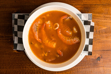 Seafood soup in a white bowl