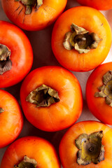 Raw Organic Orange Persimmons, top view. Flat lay, overhead, from above.