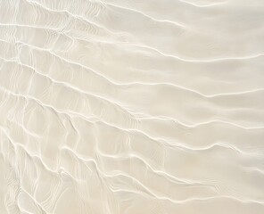 A serene sandy beach scene where gentle waves meet the shore in clear, shallow water