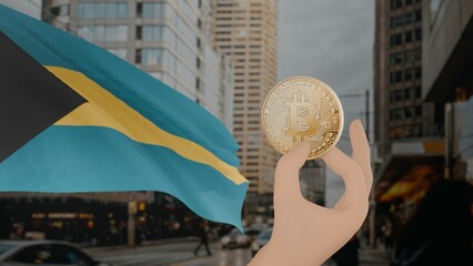 Golden bitcoin held by a hand with a waving Bahamas flag in the background against a modern urban...