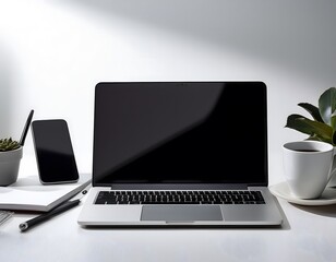 Fototapeta premium A minimalist workspace featuring a sleek laptop, smartphone, and a notebook, with a cup of coffe