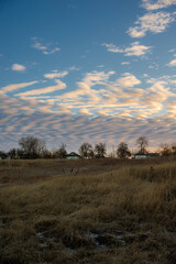 Snowy and frosty field with road,sunrise in the sky.Beautiful clouds in the sky.Nature at the winter time.Winter morning, sunlights over the road , beautiful nature landscape