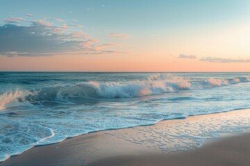 Sunset over the ocean with waves crashing on the sandy beach in a tranquil coastal setting during early evening