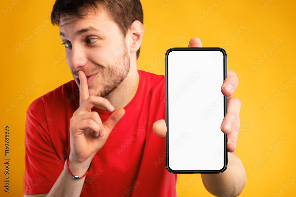 Aufkleber man with white blank cellphone screen holding index finger on lips, showing gesture of secret, empty