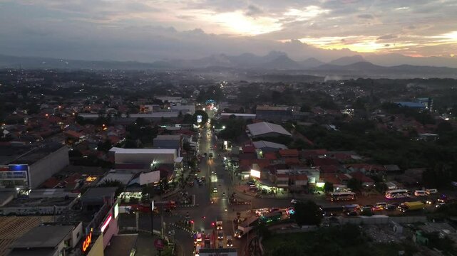Drone view of traffic light intersection in Purwakarta, West Java. Beautiful sunset sky and busy city. 