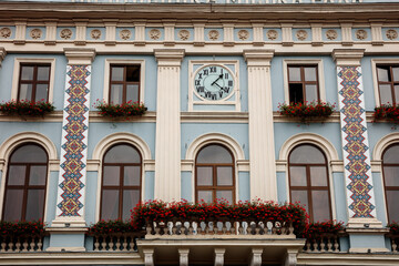 A clock tower with a clock face and a large window