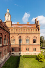 Fototapeta premium A brick building with a clock tower and a large window