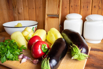 Colorful vegetables and herbs arranged on a wooden kitchen countertop