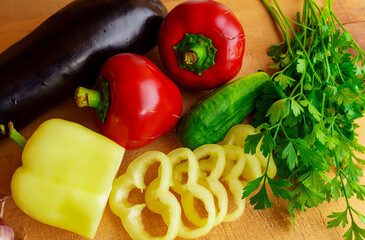 Colorful assortment of fresh vegetables on a wooden cutting board