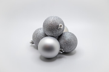 Group of silver glittered round Christmas tree balls, with white background and copy space