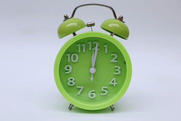 Green alarm clock on white background