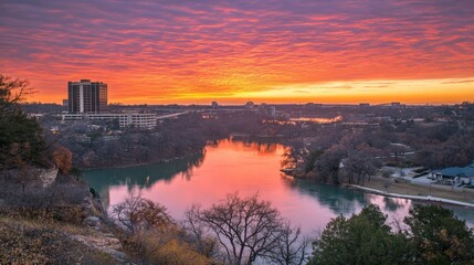 Serene Sunset Over River with Urban Landscape and Colorful Sky