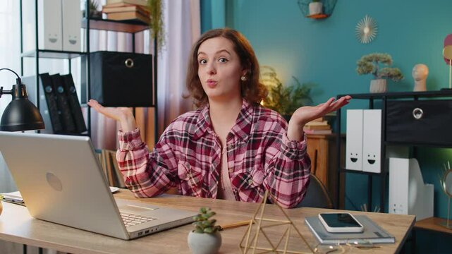 I don't know what to say. Confused businesswoman working on laptop at office workplace. Freelancer feeling embarrassed about ambiguous question having doubts, no answer idea, being clueless, uncertain